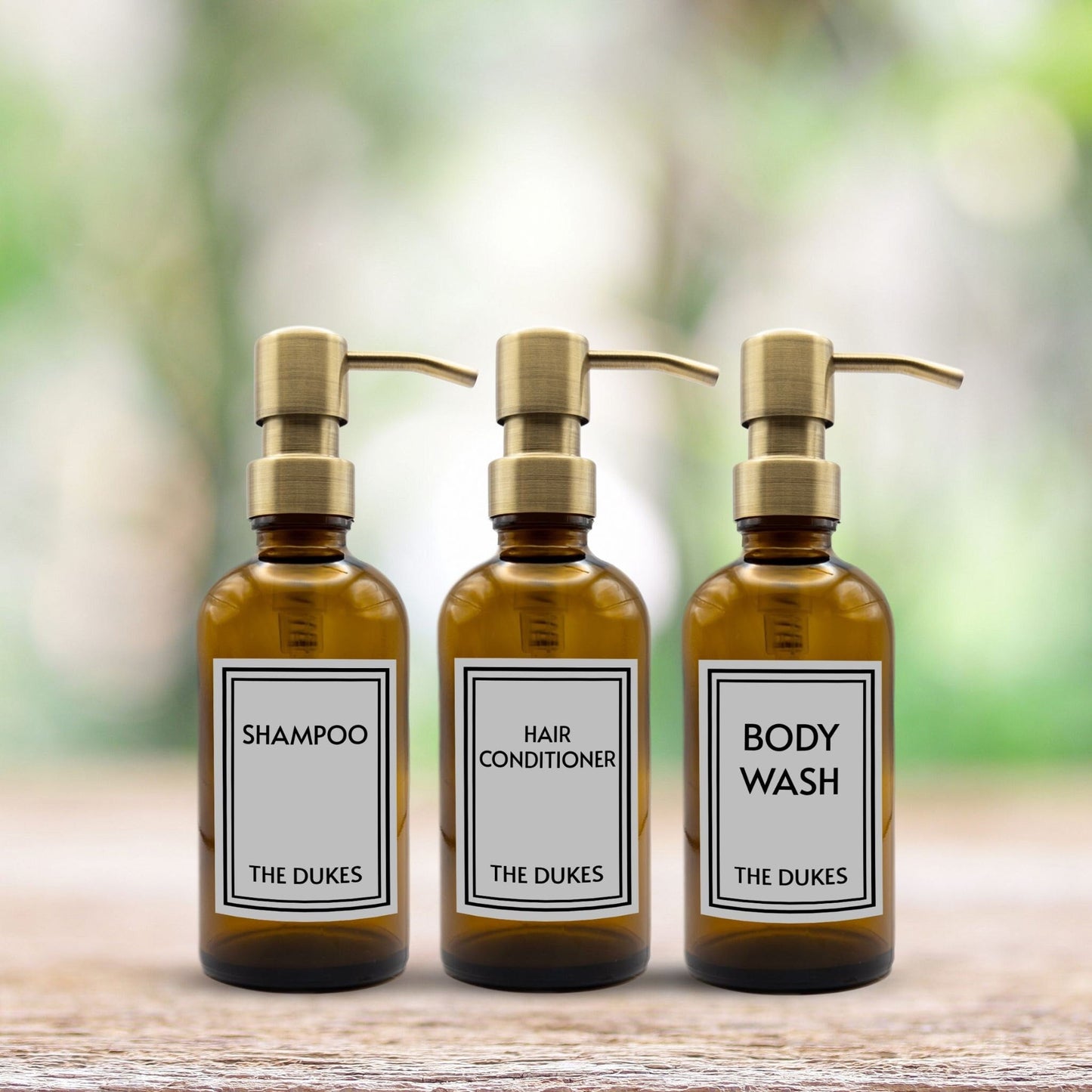 shampoo, hair conditioner and body wash set of three amber glass dispenser bottles for bathroom with custom labels and gold pumps