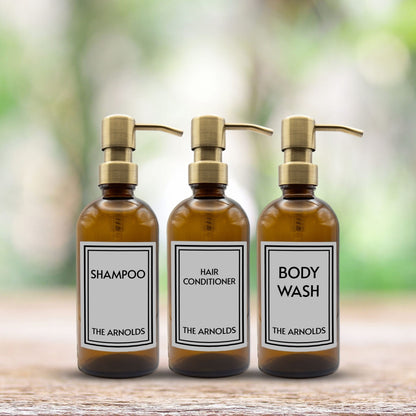 shampoo, hair conditioner and body wash set of three amber glass dispenser bottles for bathroom with custom labels and gold pumps