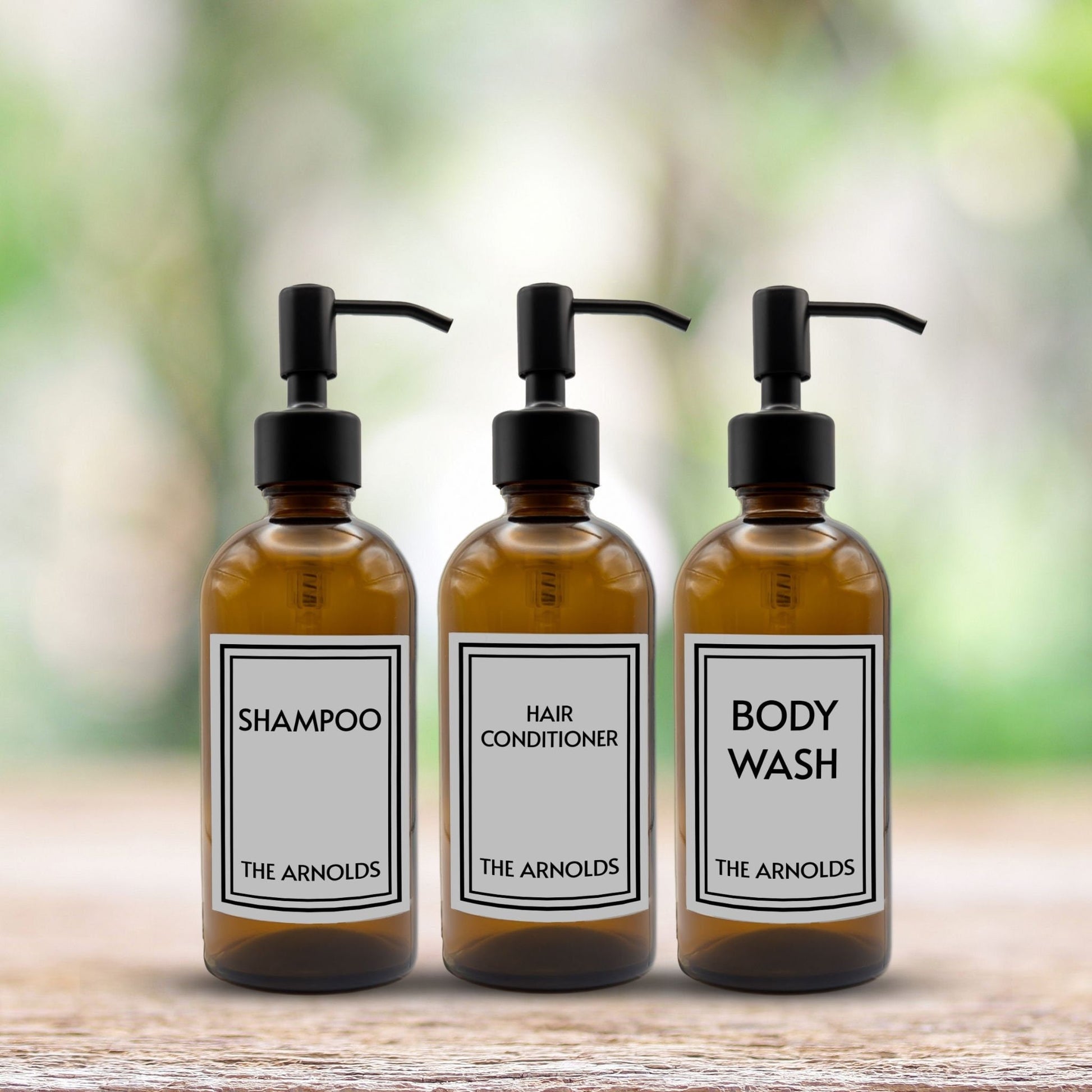 shampoo, hair conditioner and body wash set of three amber glass dispenser bottles for bathroom with custom labels and black pumps