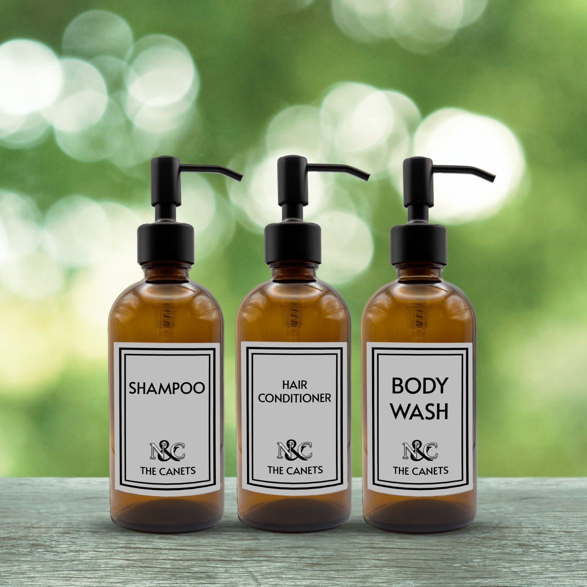 shampoo, hair conditioner and body wash set of three amber glass dispenser bottles for bathroom with custom monogrammed labels and black pumps