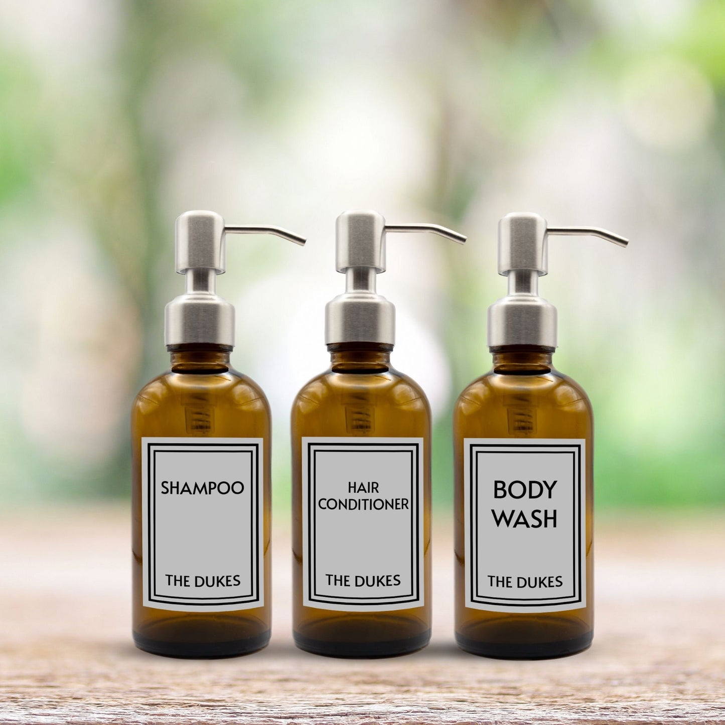 shampoo, hair conditioner and body wash set of three amber glass dispenser bottles for bathroom with custom labels and silver pumps